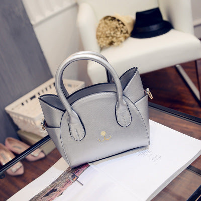 Nine Lives Cat Pattern Handbag in silver, front view