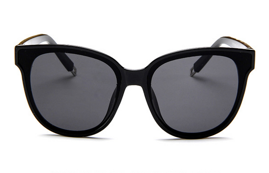 Black sunglasses with gold accents on a white background