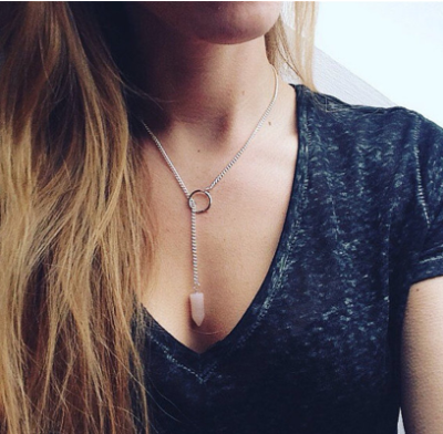 Person wearing a necklace with a pendant