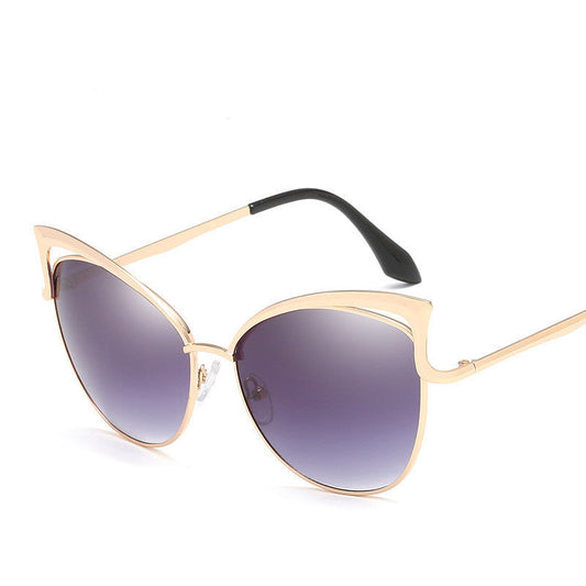 Sunglasses with gold frame and gray gradient lenses on a white background