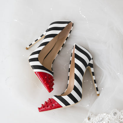 Black and white striped high heels with red soles on a white background