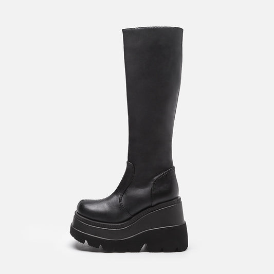 Black knee-high platform boot on a white background