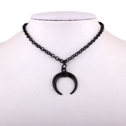 Black crescent moon necklace on a mannequin with a white background