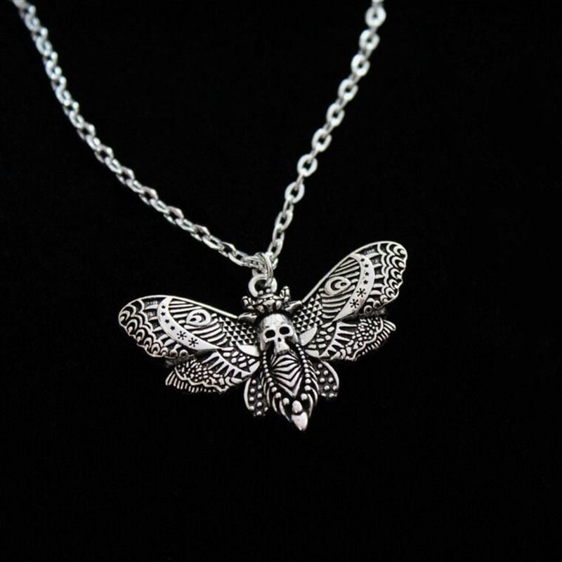 Silver butterfly pendant necklace on a black background