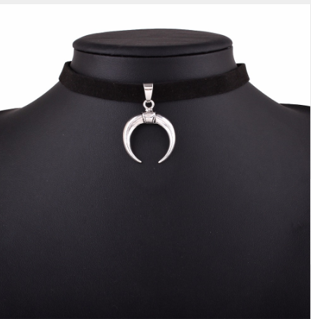Black choker necklace with a silver crescent moon pendant on a mannequin.