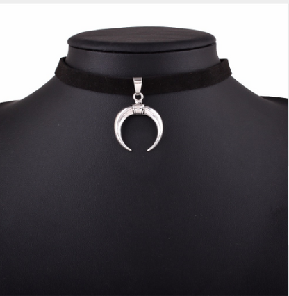 Black choker necklace with a silver crescent moon pendant on a mannequin.