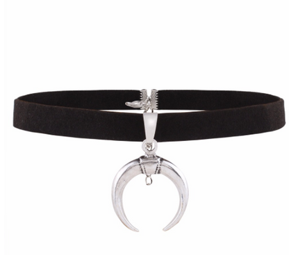 Black choker necklace with silver crescent moon pendant on a white background