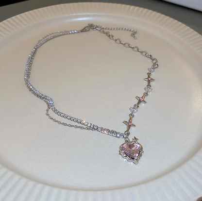 Necklace with a heart-shaped pink pendant on a white plate