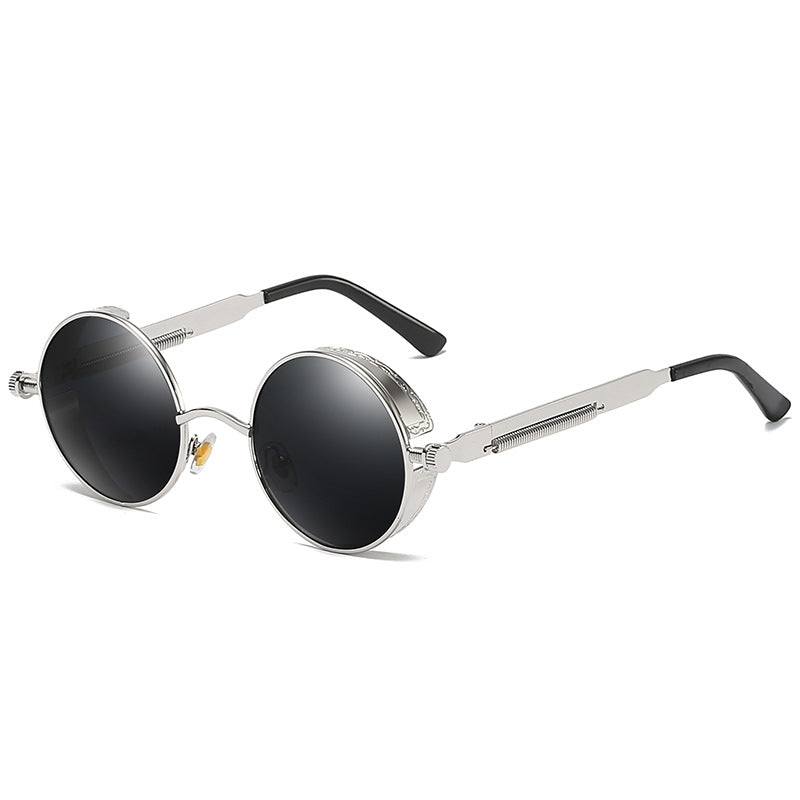 Round-frame sunglasses with silver metal rims, dark lenses, and black temple tips, shown on a clean white background.