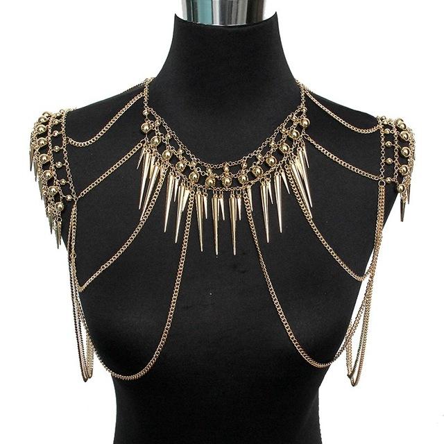 Gold chain and spike body chain on a black mannequin