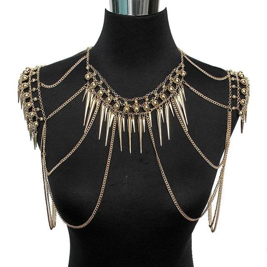 Gold chain and spike body chain on a black mannequin