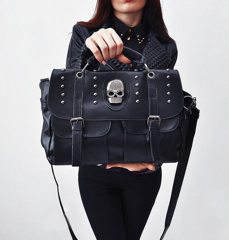 Graveprint Skull Tote Bag in black, handheld styling view