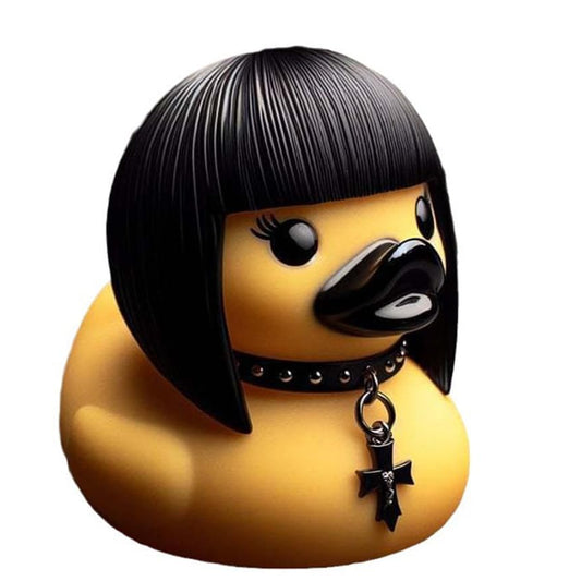 A yellow rubber duck styled with a black bob haircut, black collar, and black cross pendant, shown on a white background with a row of small alternate color variants along the bottom.