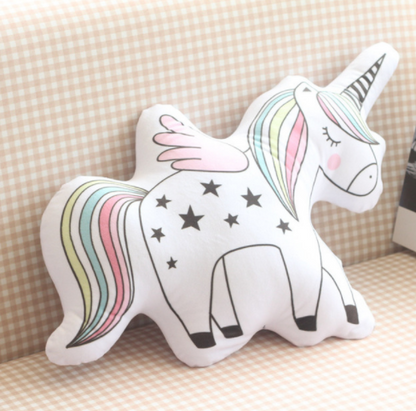 Unicorn-shaped pillow with rainbow mane and tail on a checkered background