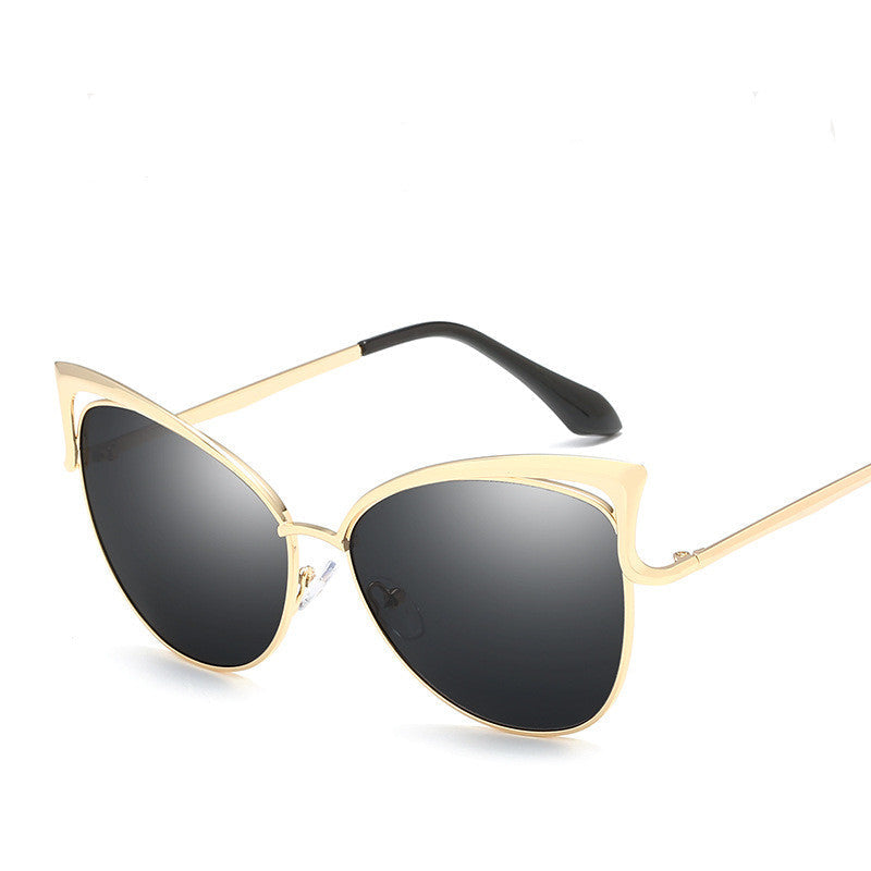 Gold-framed sunglasses with black lenses on a white background