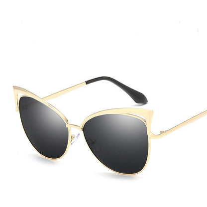 Gold-framed sunglasses with black lenses on a white background