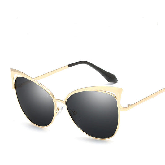 Gold-framed sunglasses with black lenses on a white background