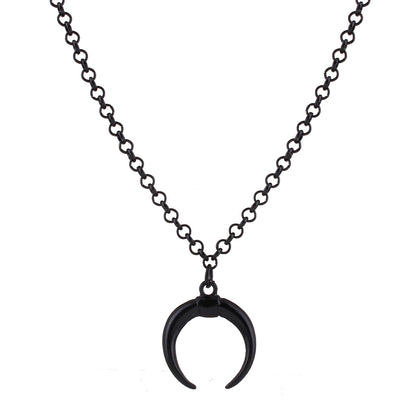 Black crescent moon pendant on a chain against a white background