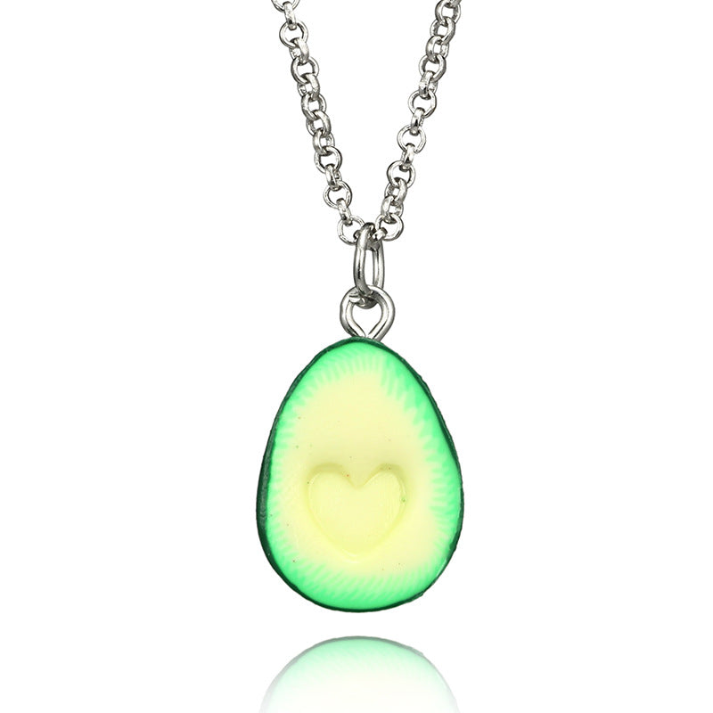 Avocado-shaped pendant on a chain against a white background